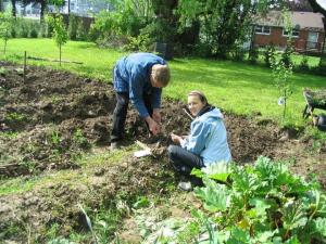 A father and daughter gardening together